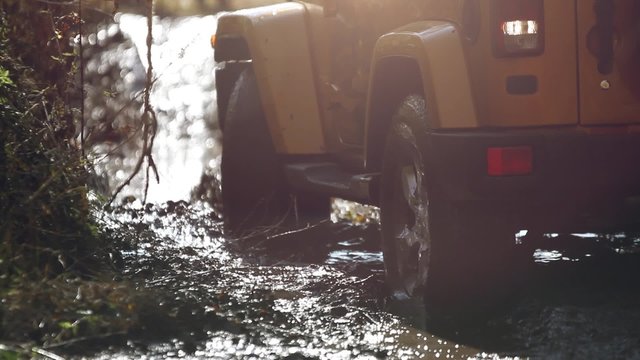 SUV got stuck in the mud and trying to go out in the autumn