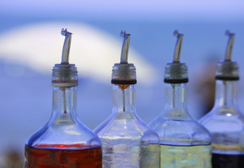 many bottles of colored syrup for preparing ice creams in summer