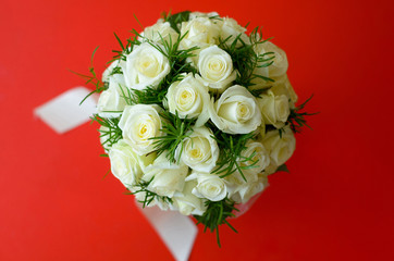 bouquet of fiancee from roses on a red background