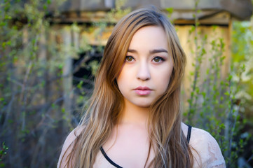 Fototapeta premium Spring portrait. Young girl on a background of old buildings