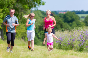Family sport running through field