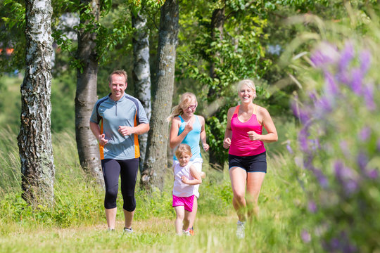 Family sport jogging through field