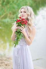 beauty woman portrait with a bouquet of red roses