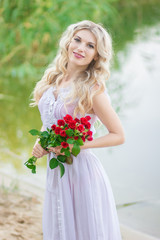 beauty woman portrait with a bouquet of red roses