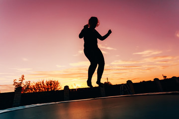 Silhouette Of Beautiful Plus Size Young Woman Girl Jumping On Tr