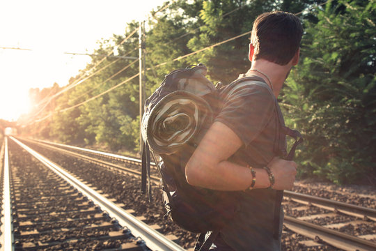 Traveler Man Crossing Rails At Sunset