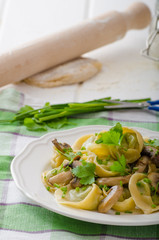 Homemade tortellini with mushrooms and herbs