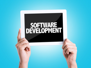 Tablet pc with text Software Development with blue background