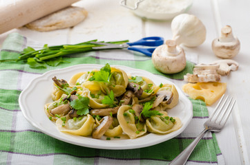 Homemade tortellini with mushrooms and herbs