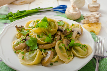 Homemade tortellini with mushrooms and herbs