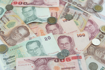 Fototapeta na wymiar Random Thai Baht coins and banknotes as background