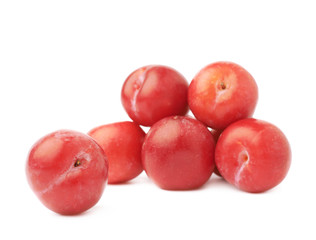 Pile of multiple red plums isolated