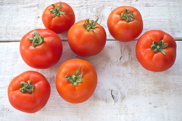Tomatoes on white wooden surface