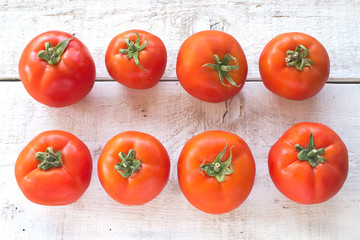 Tomatoes on white wooden surface