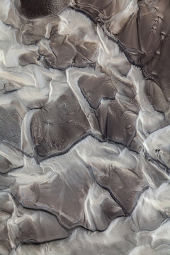 Abstract patterns made by water flowing over a volcanic valley in the interior of Iceland.