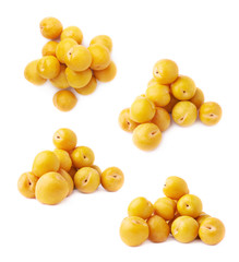 Pile of multiple yellow plums isolated