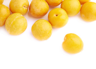 Pile of multiple yellow plums isolated