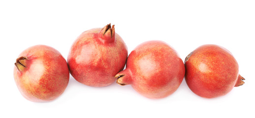 Four pomegranate fruits isolated