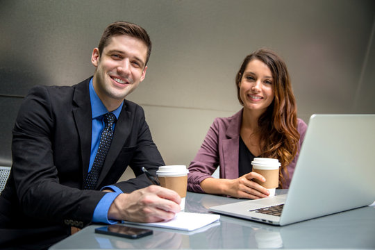 Man and woman executive business environment on computer laptop with coffee finance attorneys