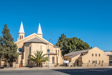 Fototapeta na wymiar Twin-spired Dutch Reformed Church and hall in Bloemfontein