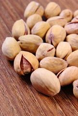 Pistachio nuts on wooden table, healthy eating
