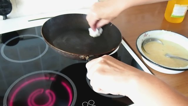 Woman cooking pancakes in the kitchen