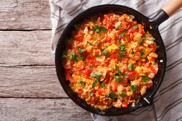 Omelette with vegetables in a pan close-up. top view horizontal
