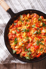 Omelette with vegetables in a pan close-up. top view vertical