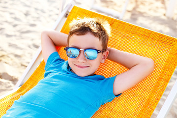 Little boy relax on deckchair © sakkmesterke