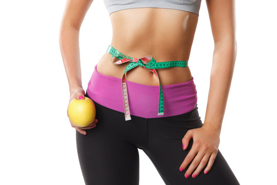 Closeup of woman stomach with measuring tape