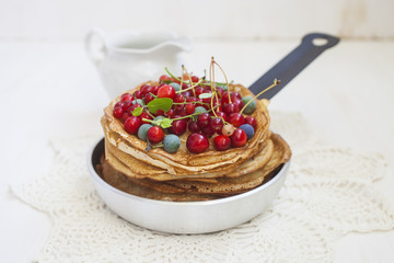 pancakes and berries in a frying pan