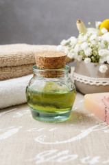 Obraz na płótnie Canvas Spa set: bottle of essential oil, soft towels, bar of soap