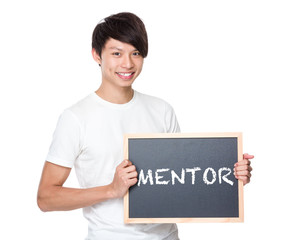 Young university student with blackboard showing a word mentor