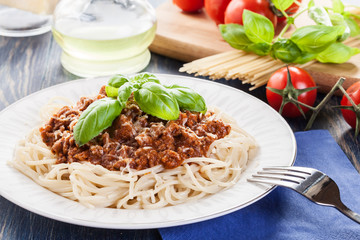 Spaghetti bolognese with cheese and basil