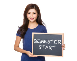 Asian woman with blackboard showing phrase of semester start