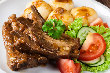 Pork spareribs served with silesian noodles and sauce