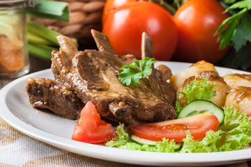 Pork spareribs served with silesian noodles and sauce
