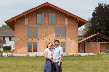 Fototapeta na wymiar Family building a house - real estate