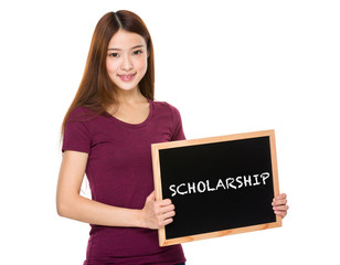 Young student hold with chalkboard showing a word scholarship