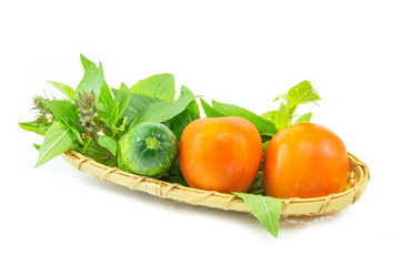 Vegetable set in the wicker basket on white background