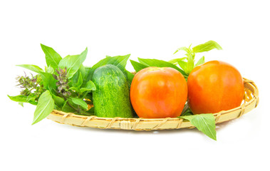 Basil tomato and cucumber in wicker basket