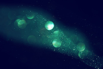 Obraz na płótnie Canvas glitter vintage lights background. gold, green, blue and black 