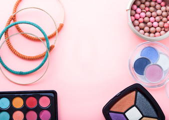 Cosmetics and accessories on pink background