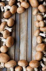 Portobello mushrooms on rustic wooden desk.