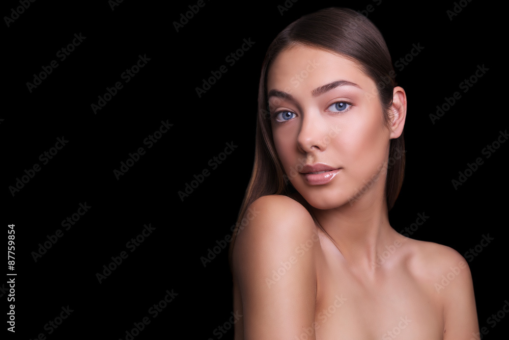 Wall mural close portrait of a beautiful girl with a natural make-up nude. isolated on black background. copy s