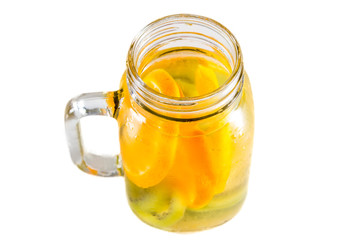 citrus fruits and kiwi, tomato in pitcher