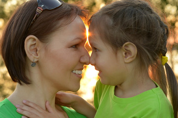 Girl with  mother in summer park