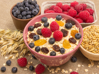Healthy porridge with fruits on canvas