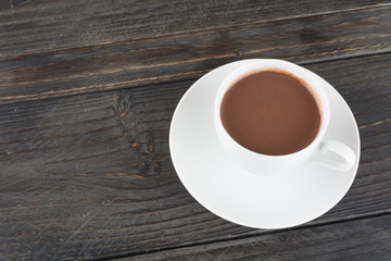 a cup of chocolate on wood table