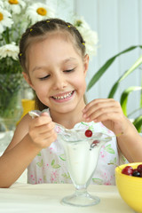 Girl eating sweet  dessert with berries